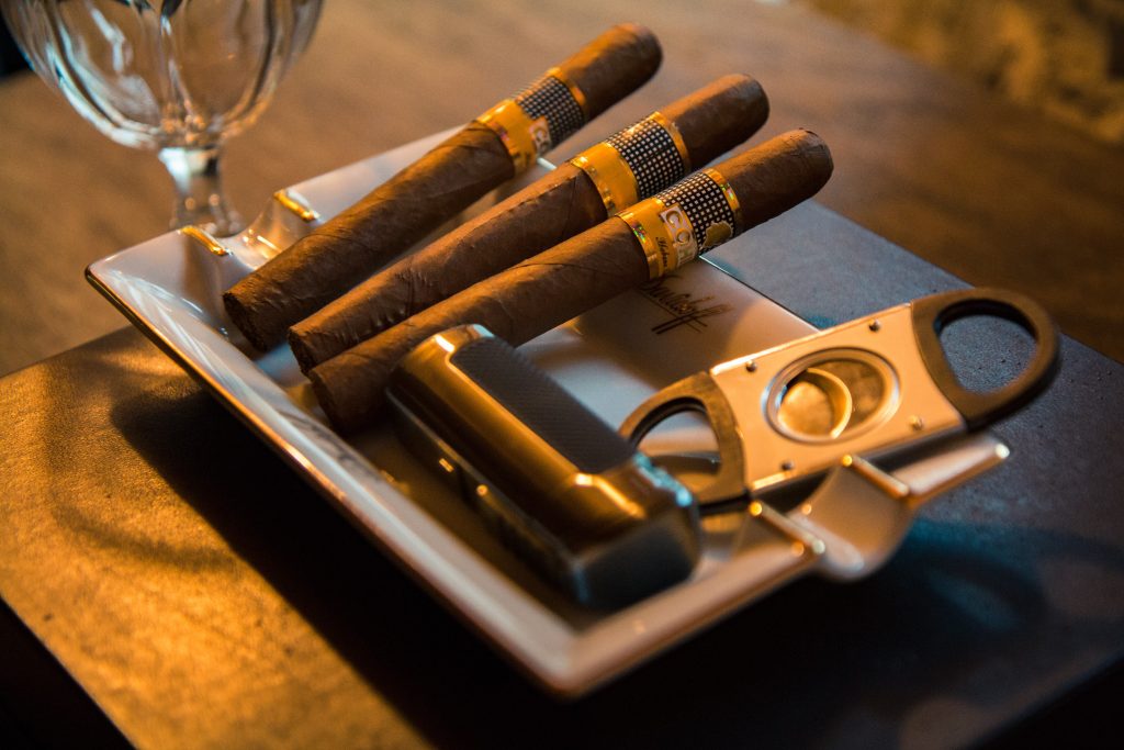 Savor Your Cigar, Cigars, Cutter, and lighter on a tray. 
